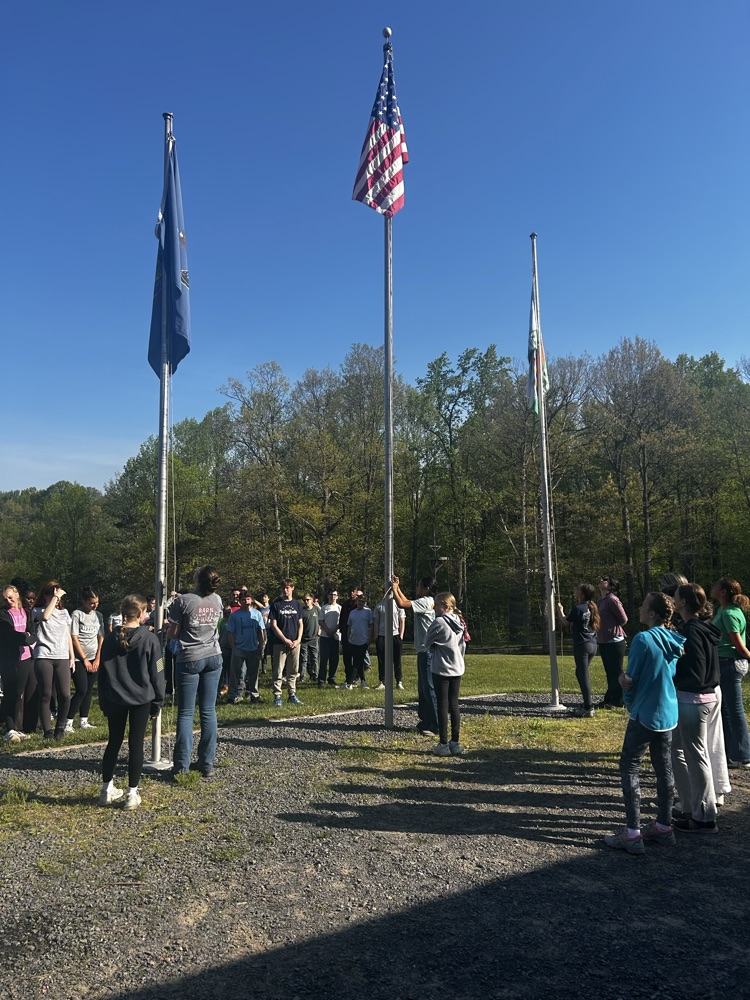 raising the flag at NEED Camp