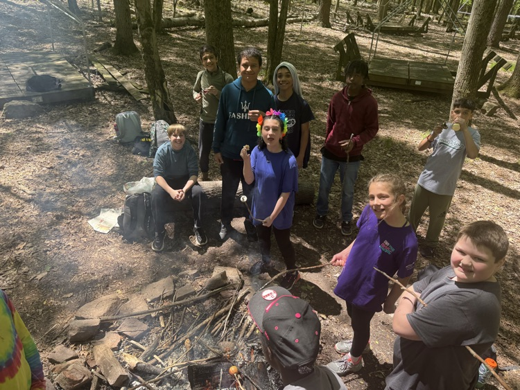 students cooking at a campfire
