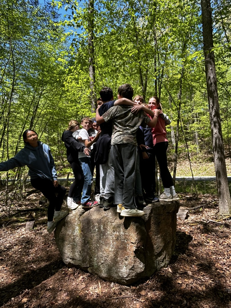students standing on a rock