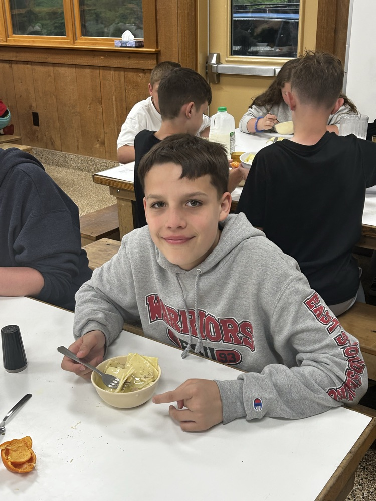 student eating in mess hall