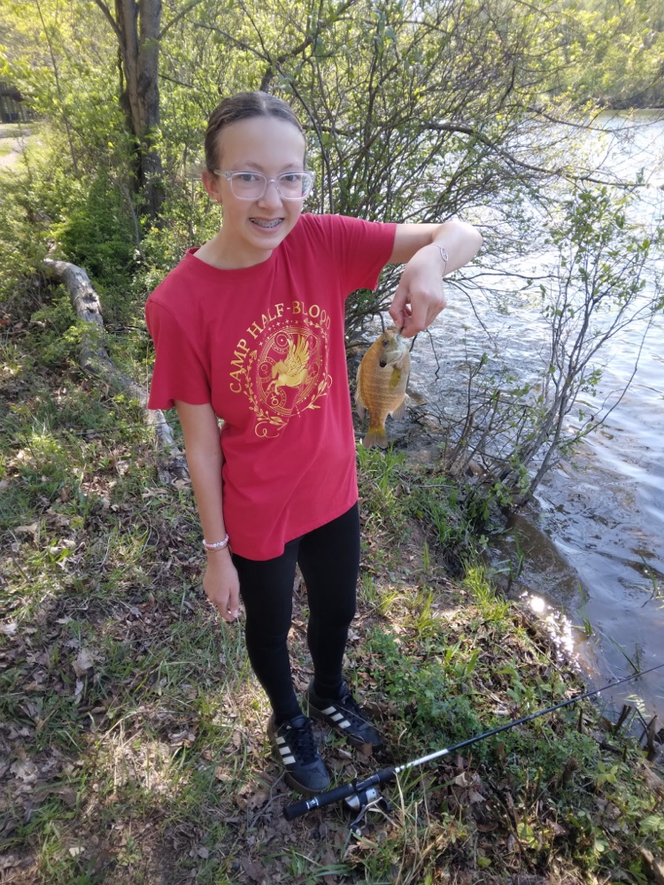 student with a fish they caught