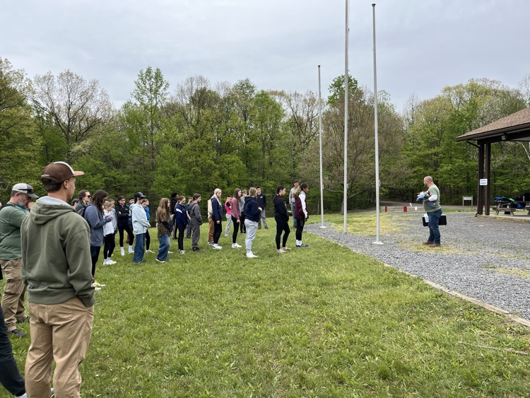 students standing at a flagpole