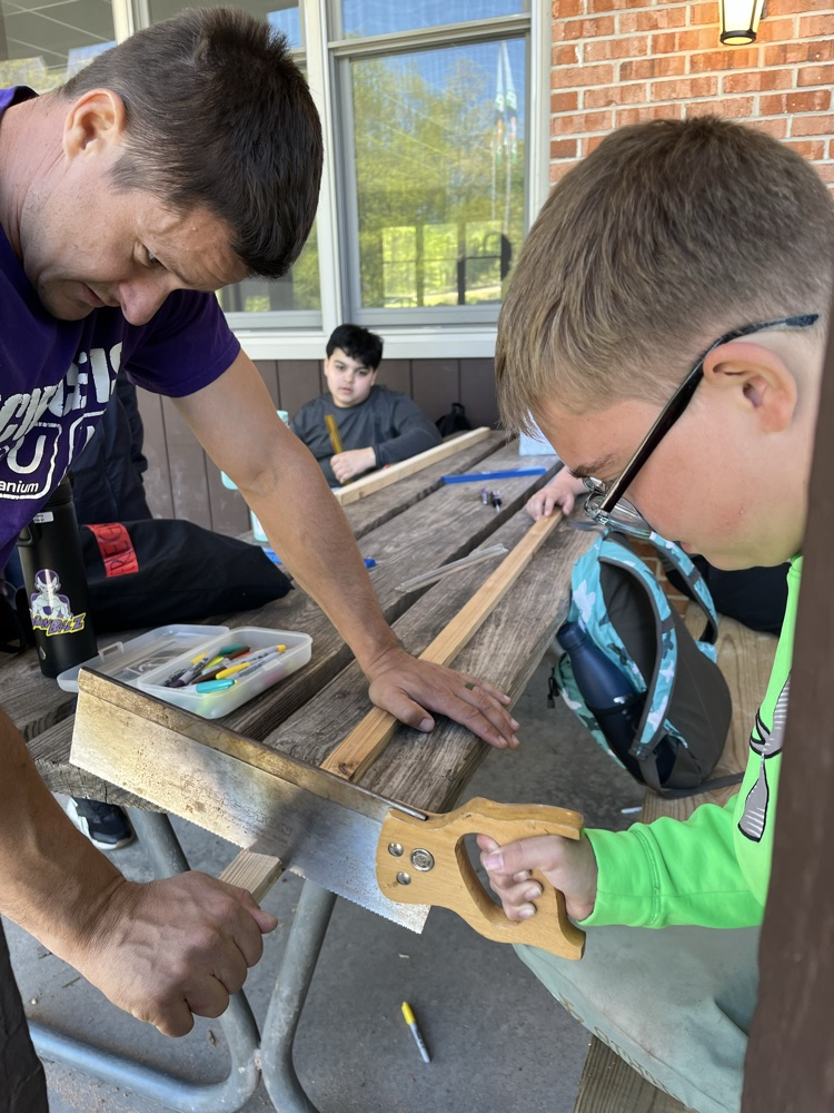 student cutting wood