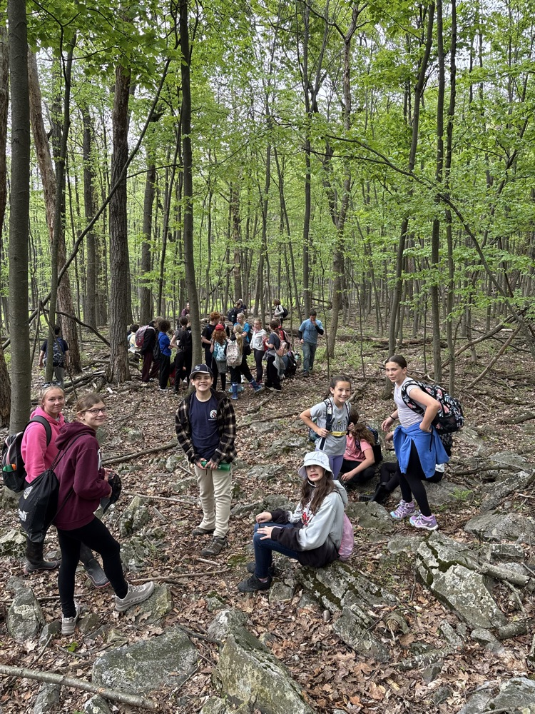 students with backpacks in the woods