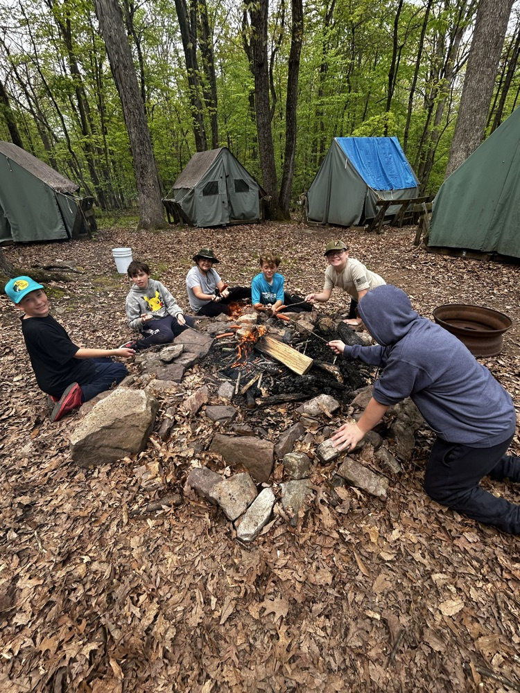 students cooking over a fire
