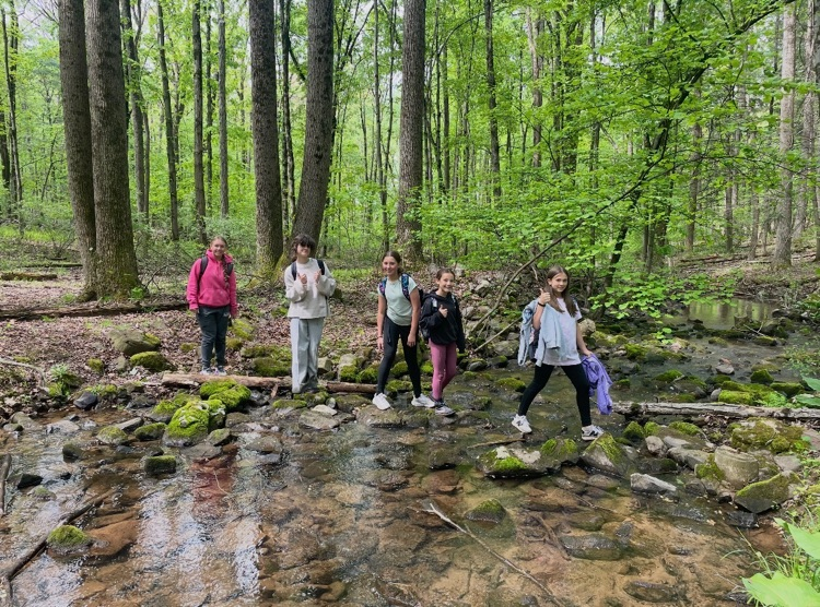 students crossing a stream