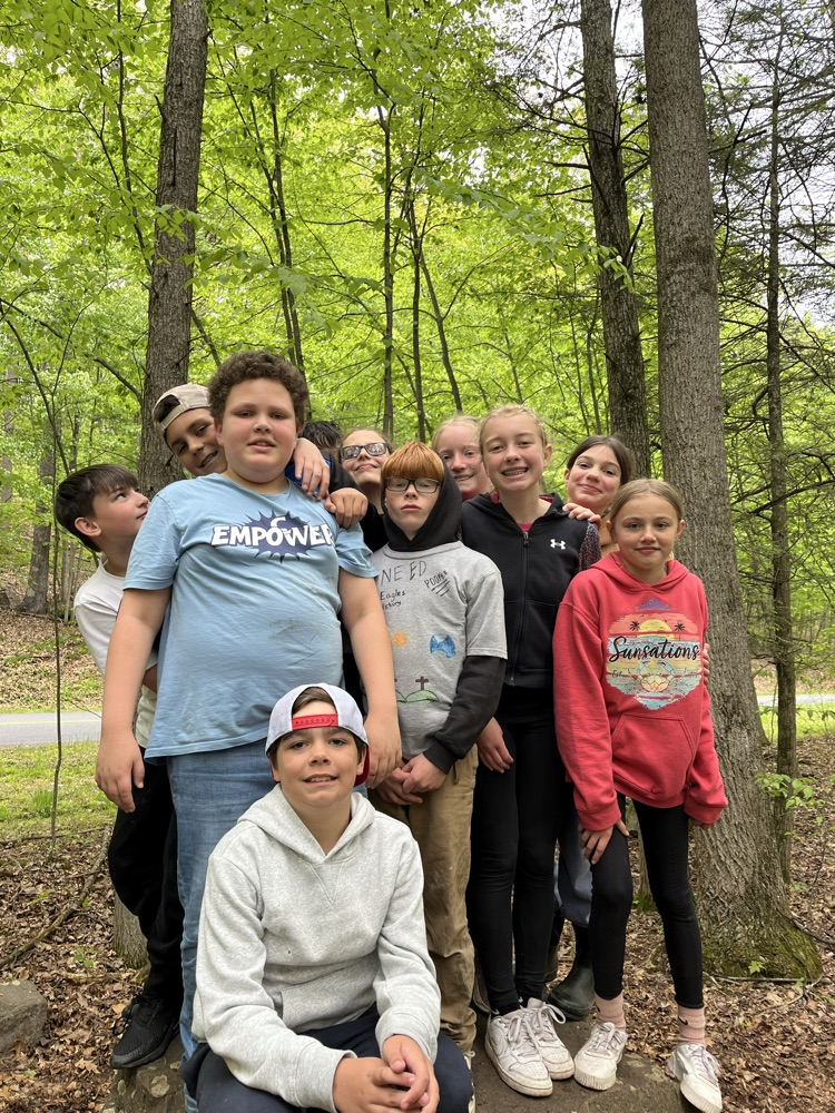 students standing together on a boulder