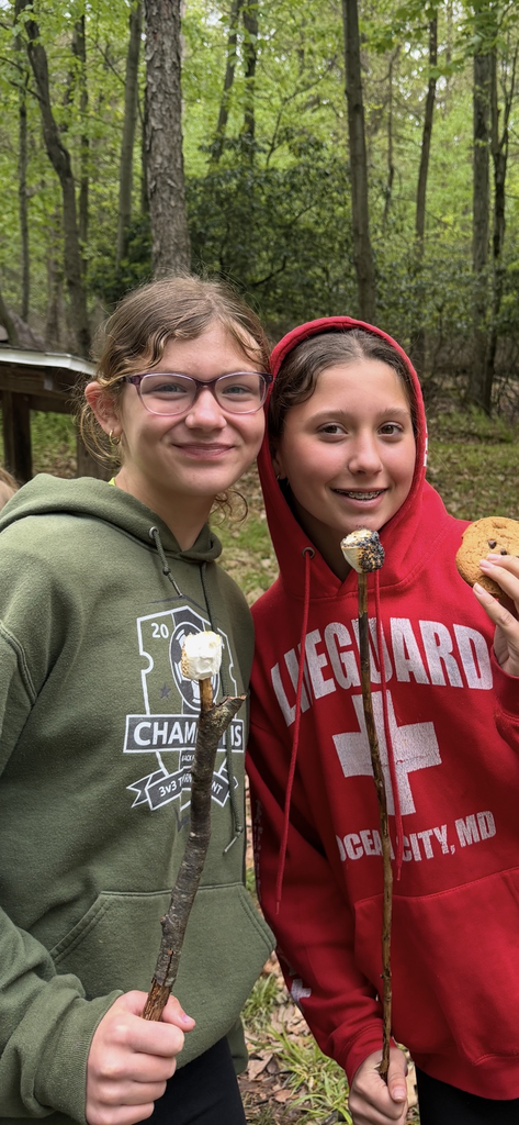 students with marshmallows roasted on a fire