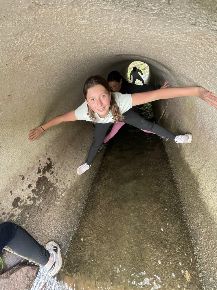student in a concrete tube
