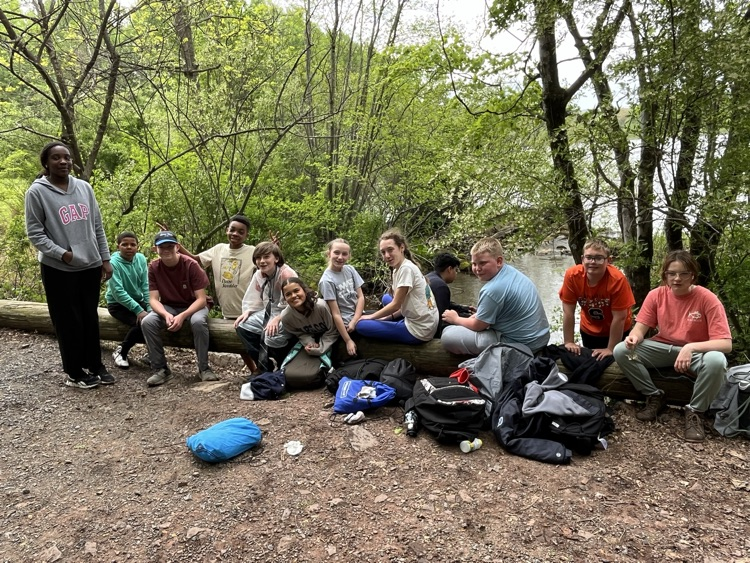 students sitting on a log
