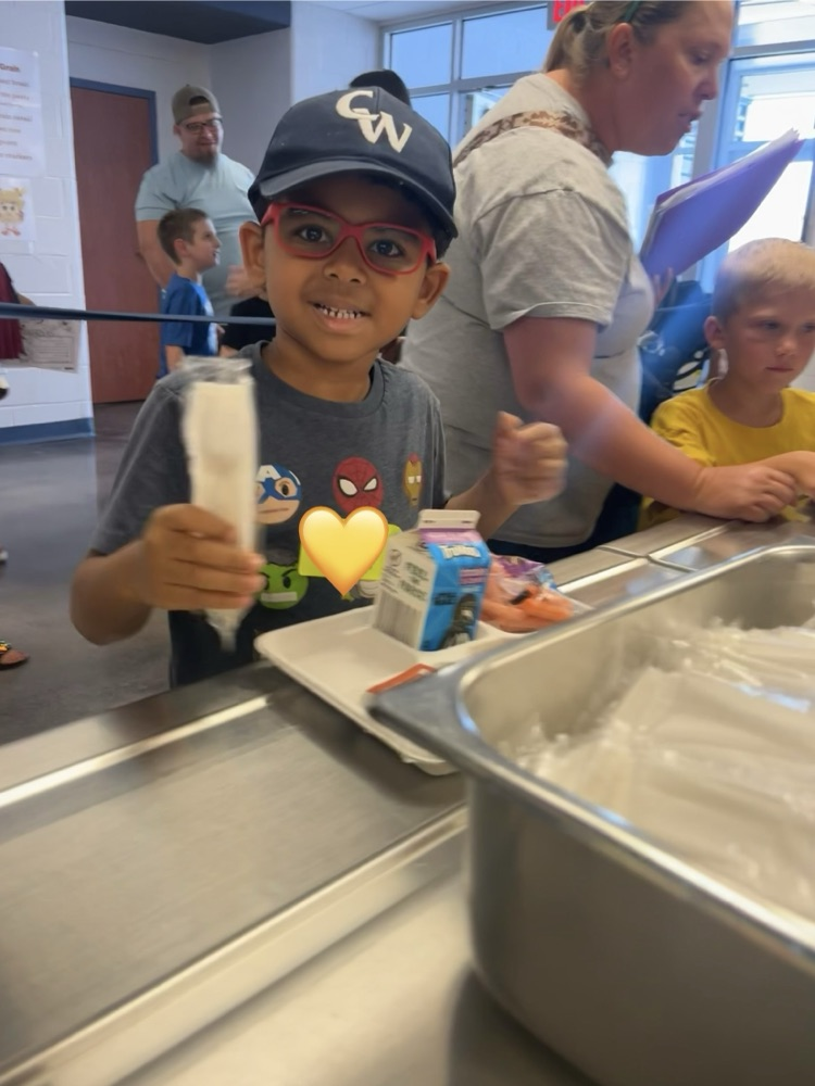 student posing in the lunch line