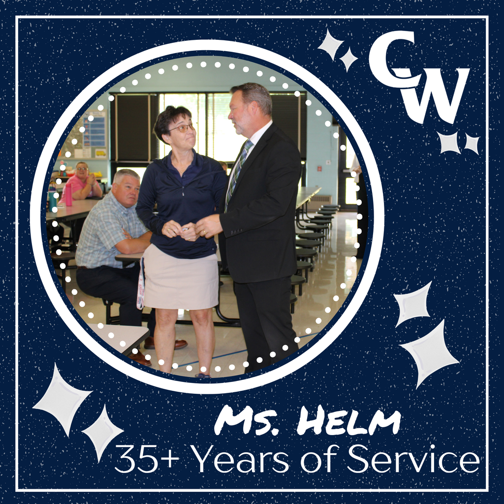 photo of superintendent giving teacher a 35 year pin