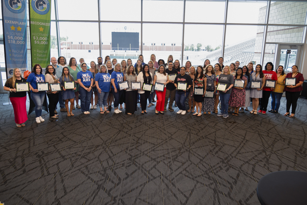Several teachers holding their TIA certificates.