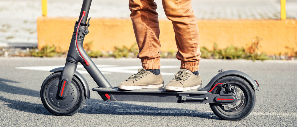 Student riding e scooter