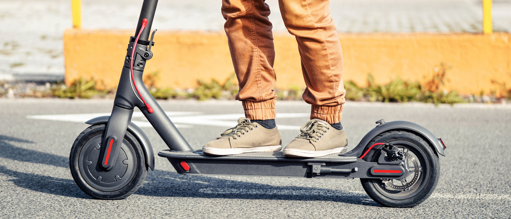 Student riding e scooter