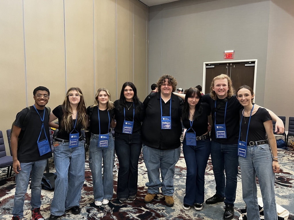 Group of students posing arm and arm.