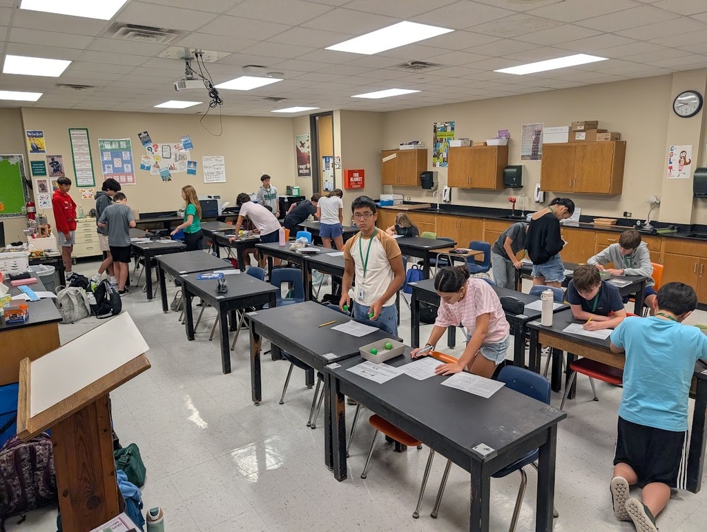 Students testing the collision of ping pong balls.