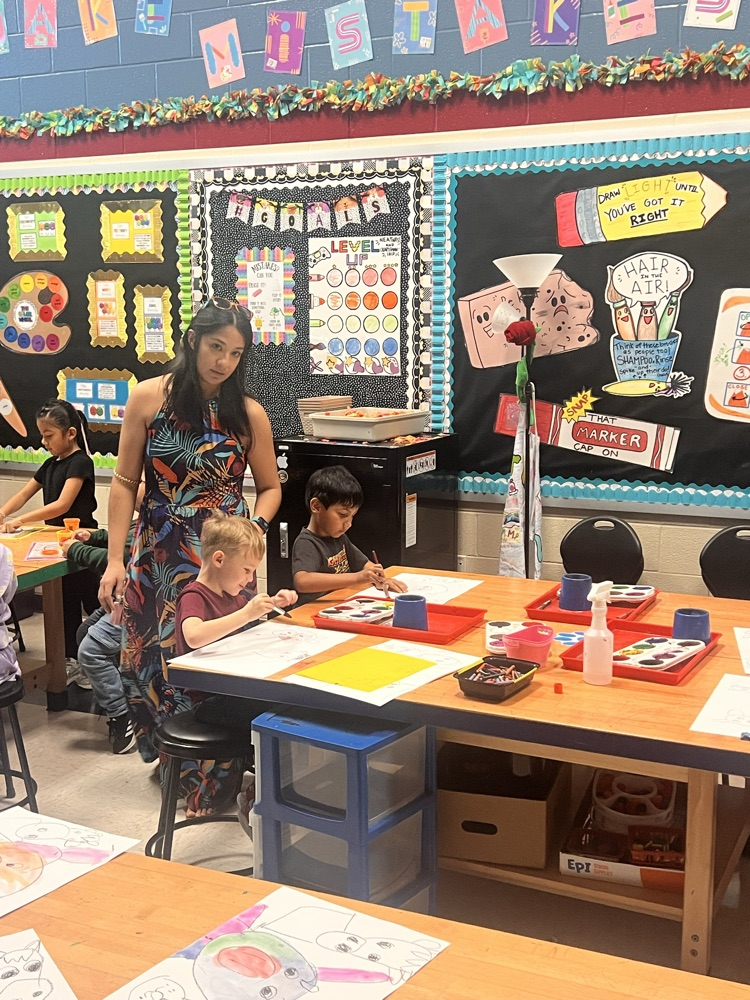 Kindergartners learning to paint in Art.