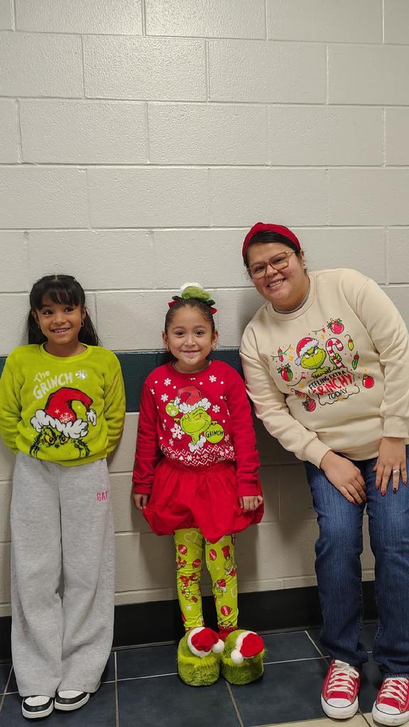 student dressed up as grinch with teacher