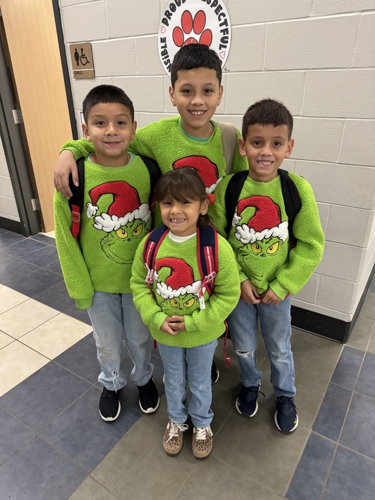 siblings wearing grinch shirts