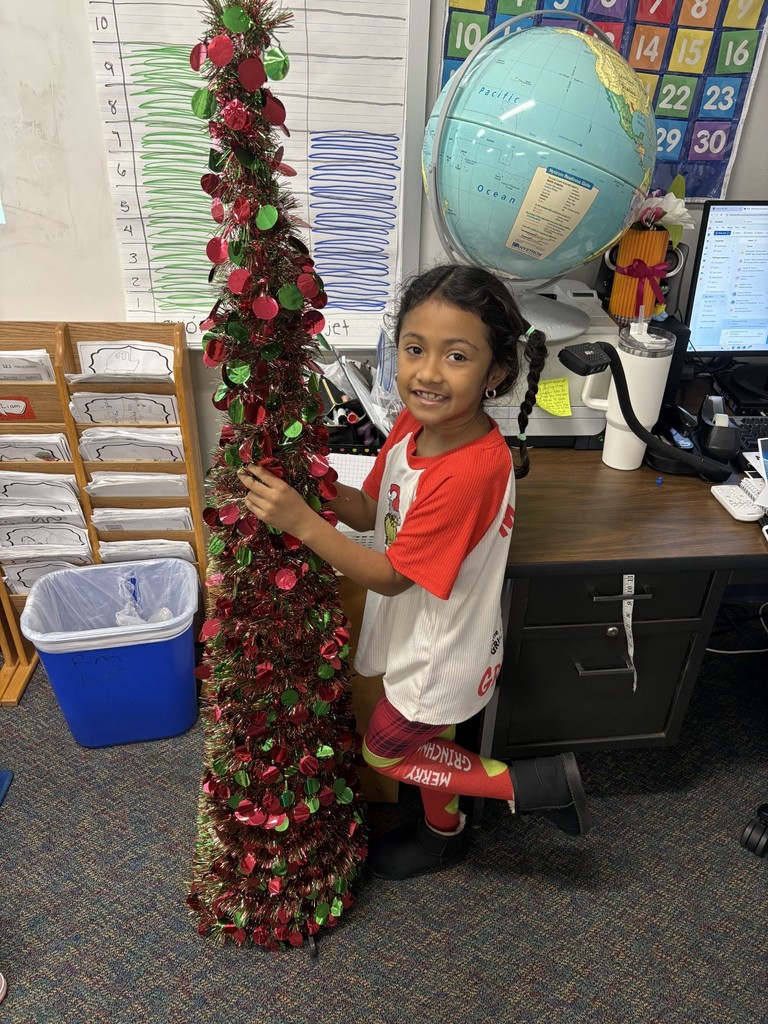 girl by christmas tree