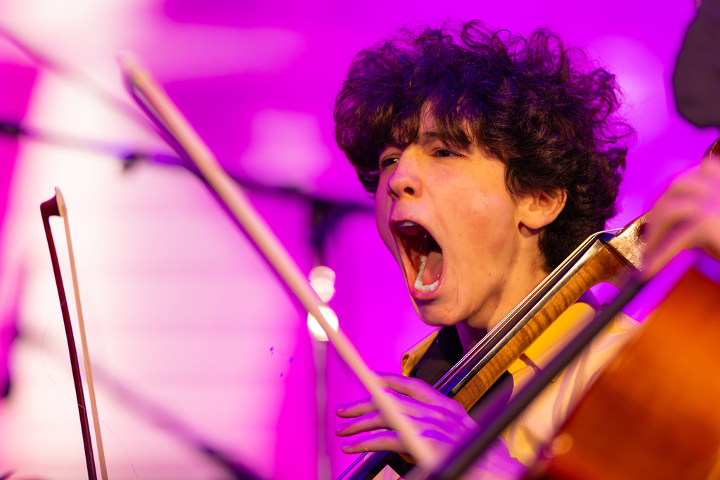 A student sings with enthusiasm during a concert performance.