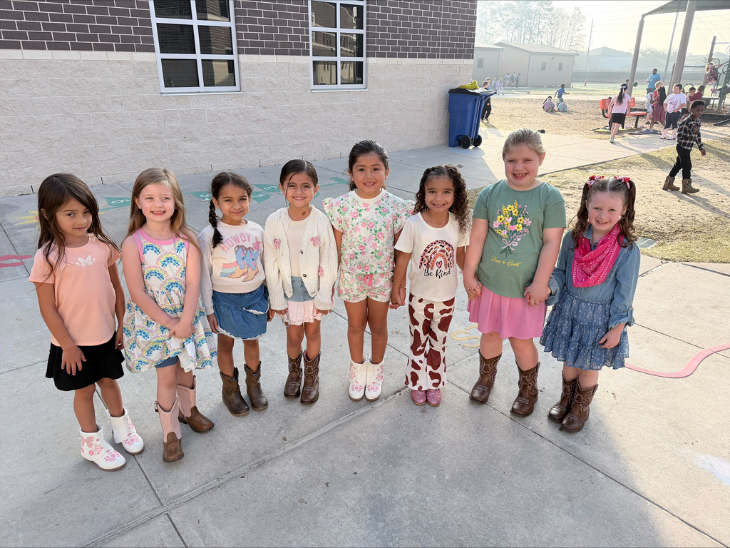 A group of students dressed for Texans Day in the playground.