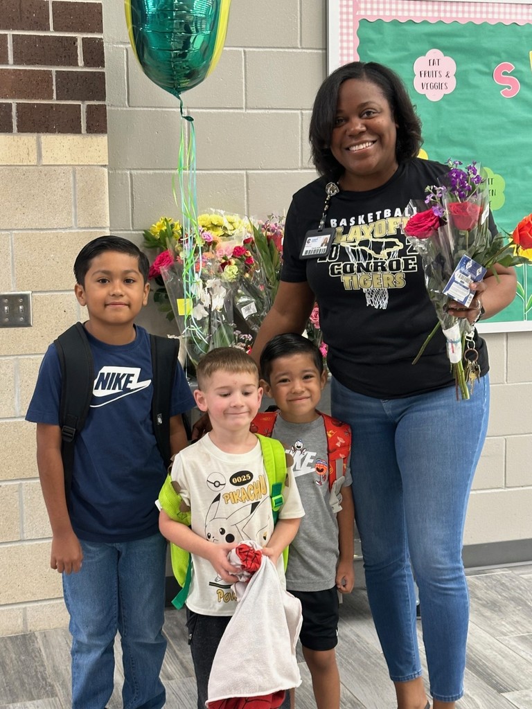 Mrs. Smith receiving flowers from several students as they walked in this morning.