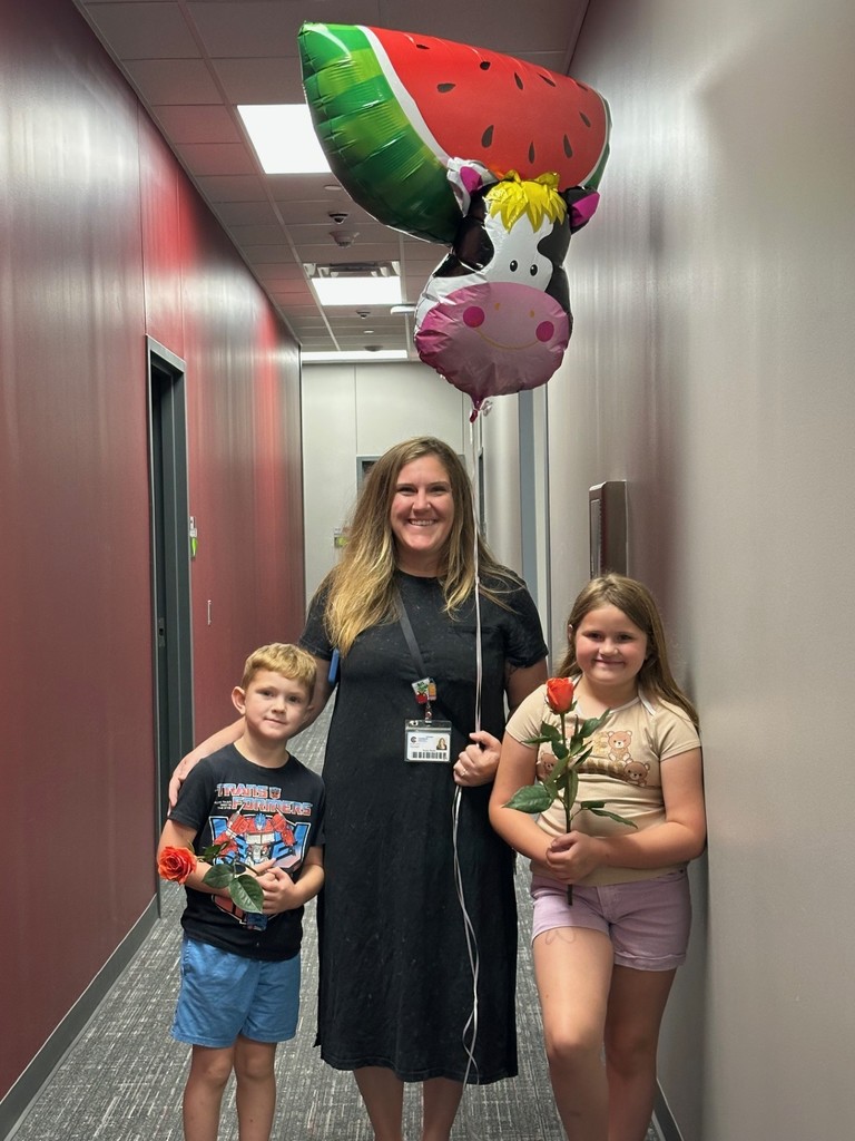 Mrs. Strain and her two little Bobcats bringing balloons and flowers early this morning to Mrs. Smith.
