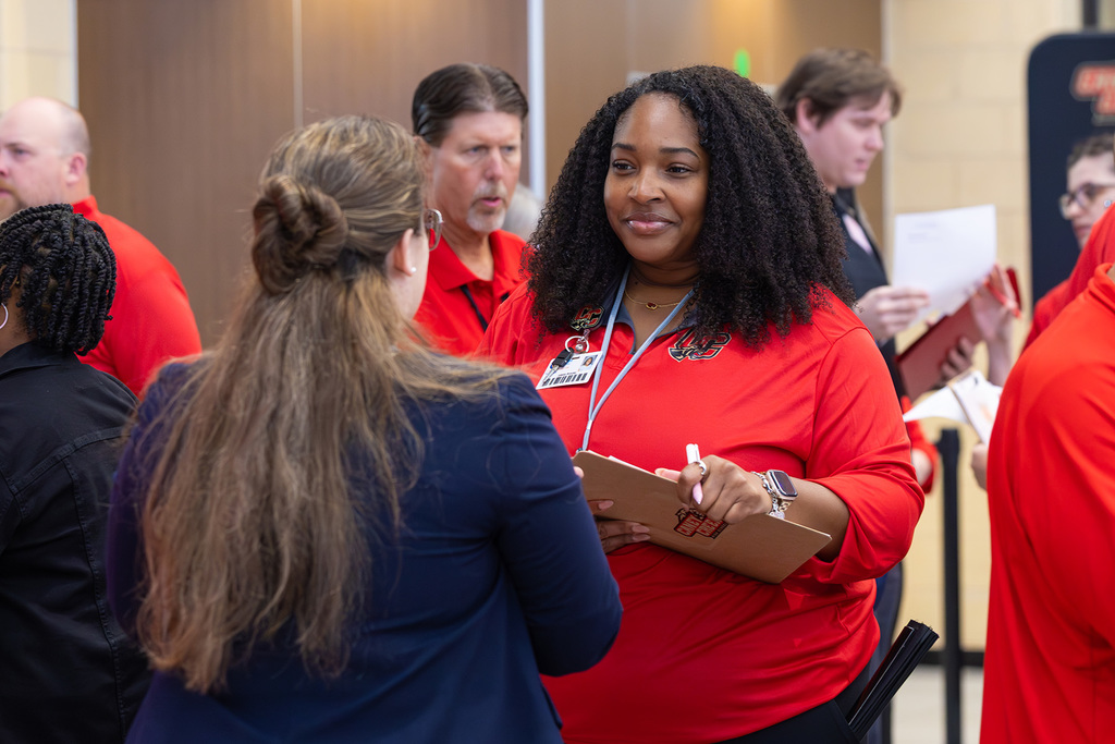 Educator speaking with an interested job candidate.