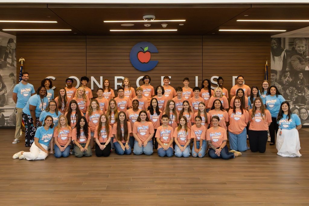 Students and staff in a group photo for an event.