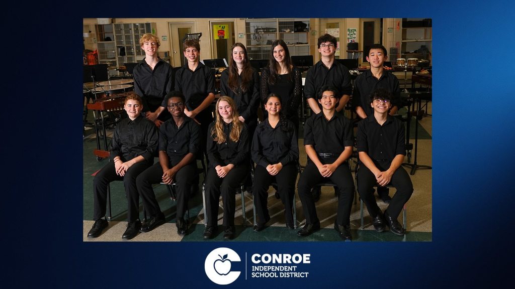 Ensembler in black attire in the music room.