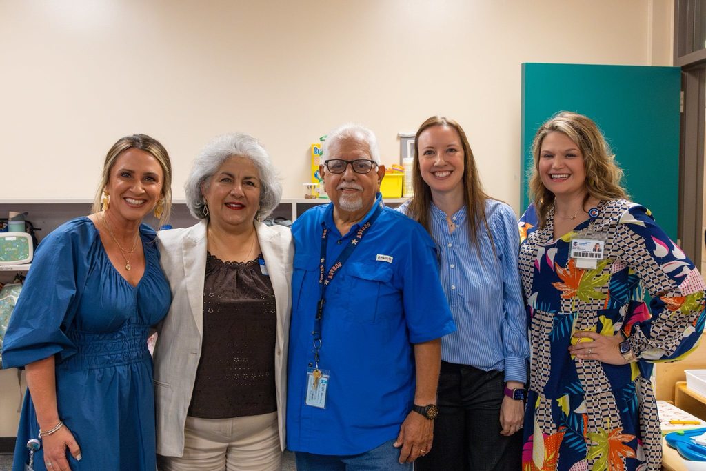 Administration congratulates staff member with award.