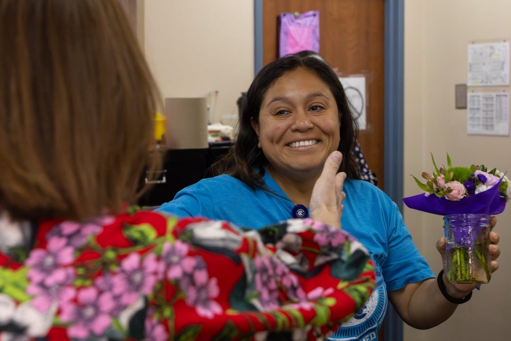 Staff member presented with flowers.