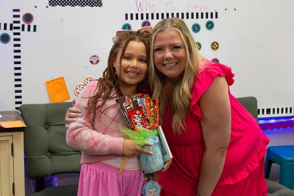 Student holds award plaque and candy bouquet joined by family.