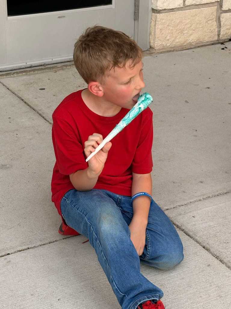 student enjoying his cotton candy
