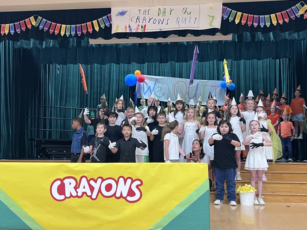 class of kids dressed in white and black with white and black gloves