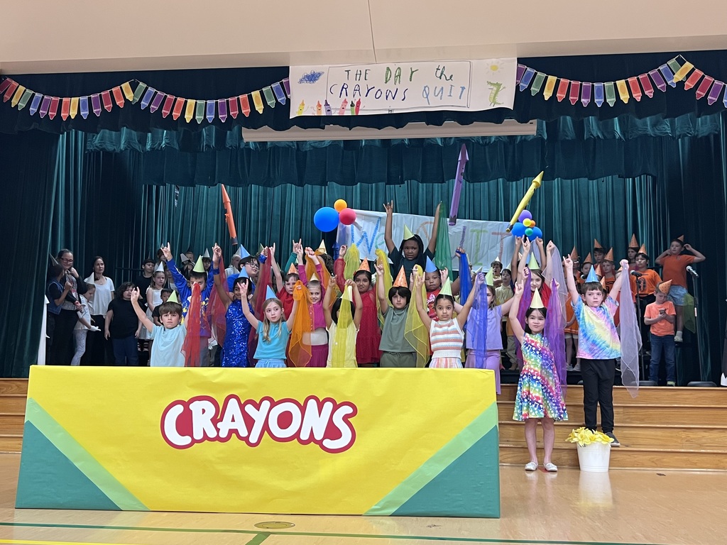 kids dressed rainbow colors with scarves in hands