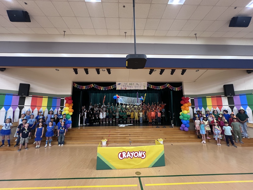 kids standing on stage smiling before program