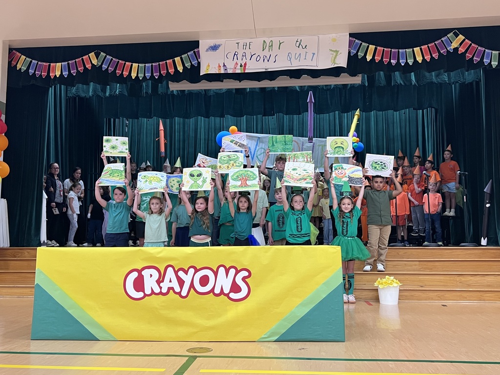 kids dressed in green holding up signs of green things