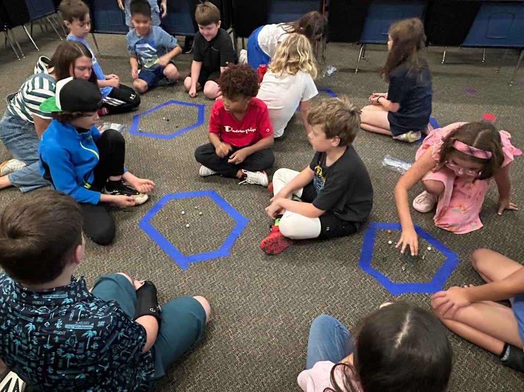 Students playing Marbles