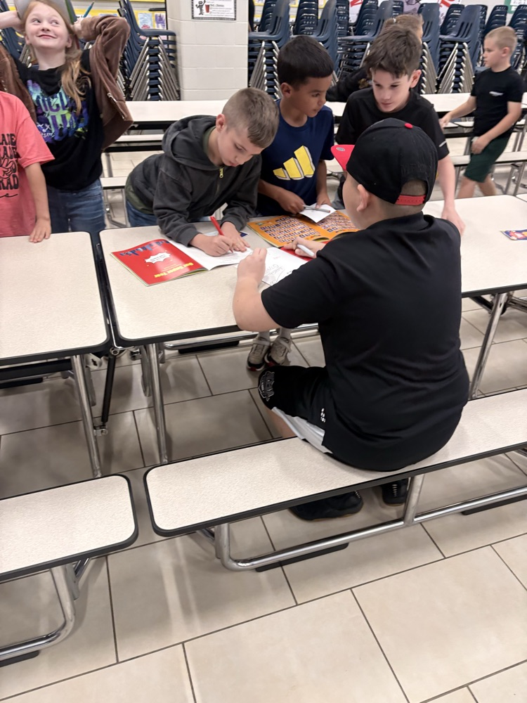 kids signing yearbooks 