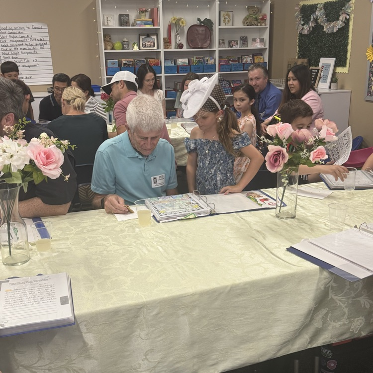girl and grandpa reading binder in class