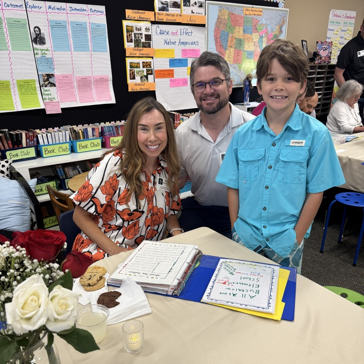 mom, dad and son in classroom