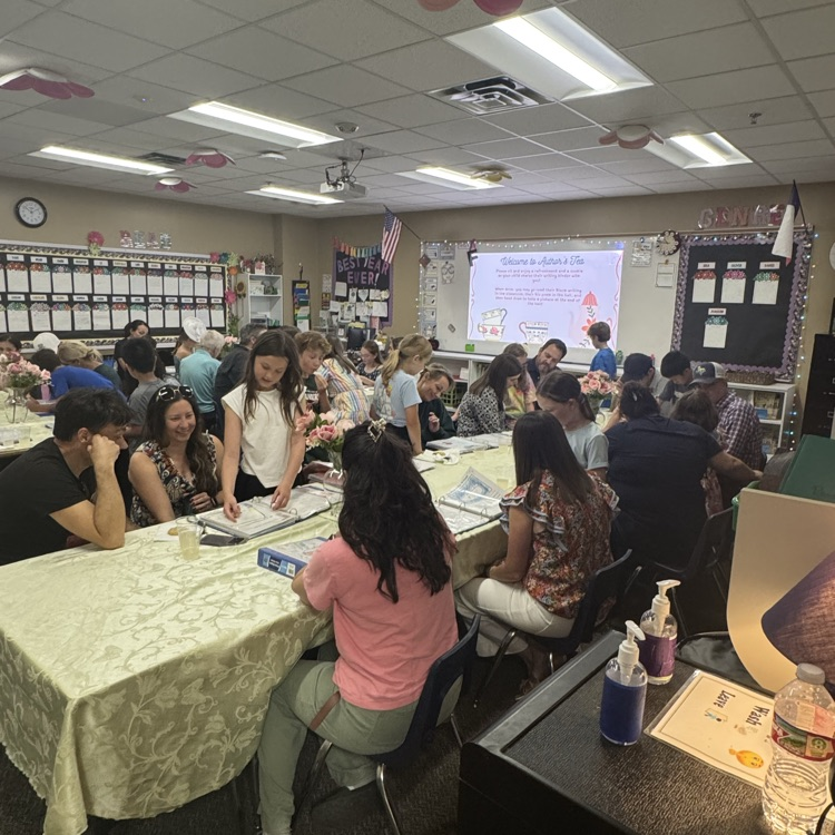class full of families looking at writing