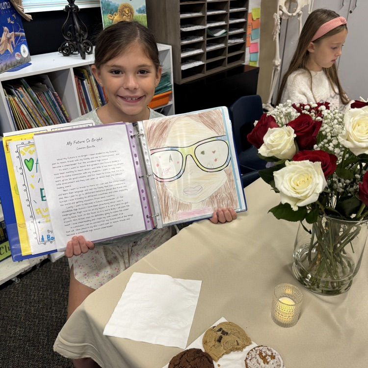 girl showing off her writing binder 