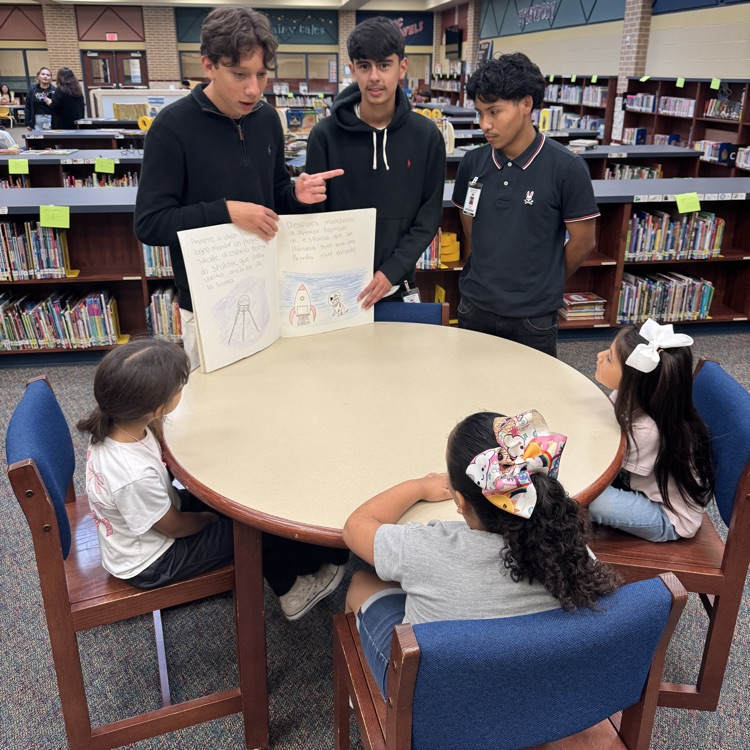 history students read books to elementary kids