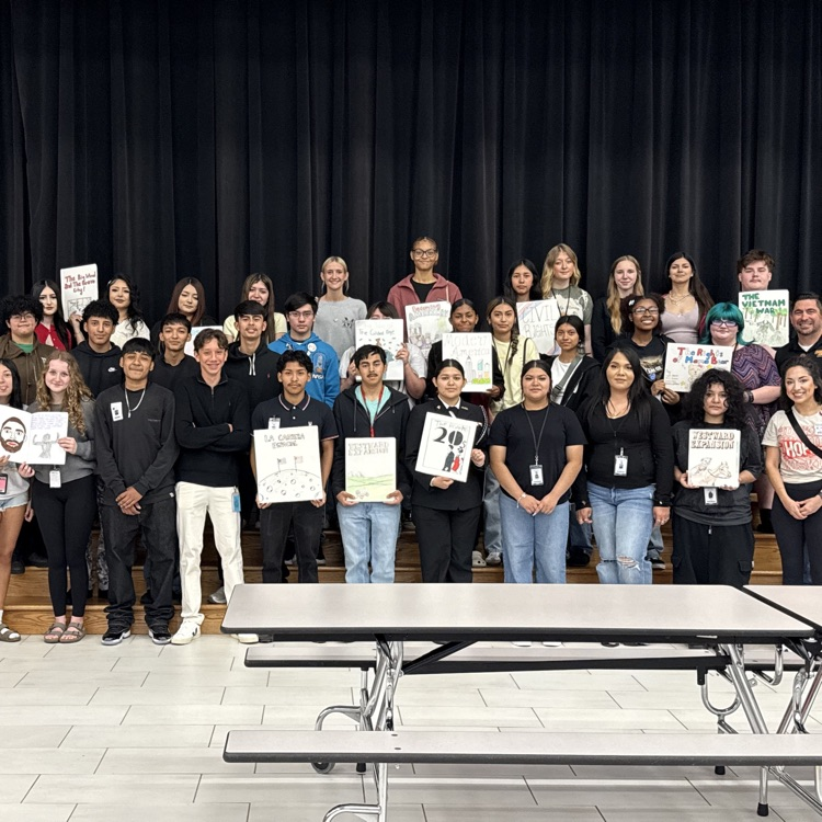 history students read books to elementary kids