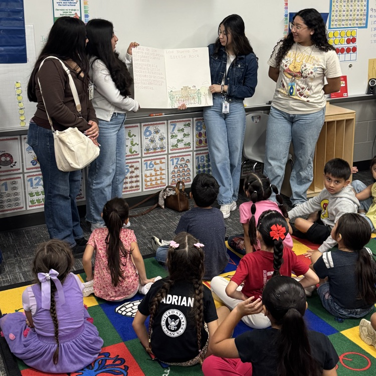 history students read books to elementary kids