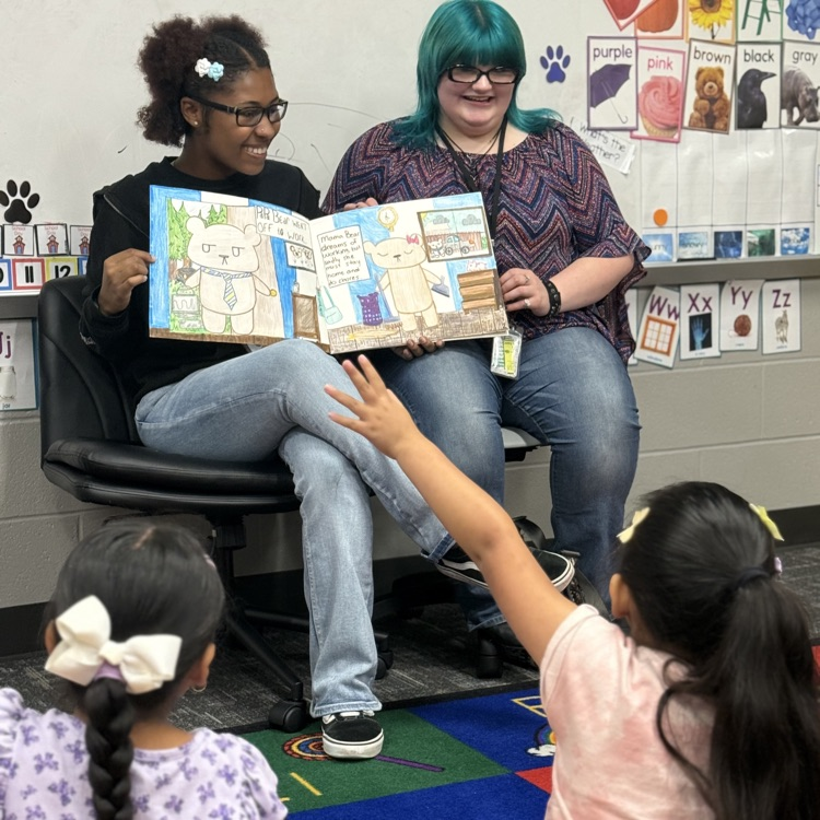 history students read books to elementary kids
